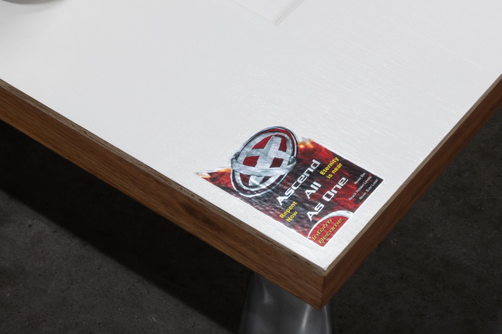 A sticker on the door's bottom-left corner, there is a metal logo on the sticker and the texts: 