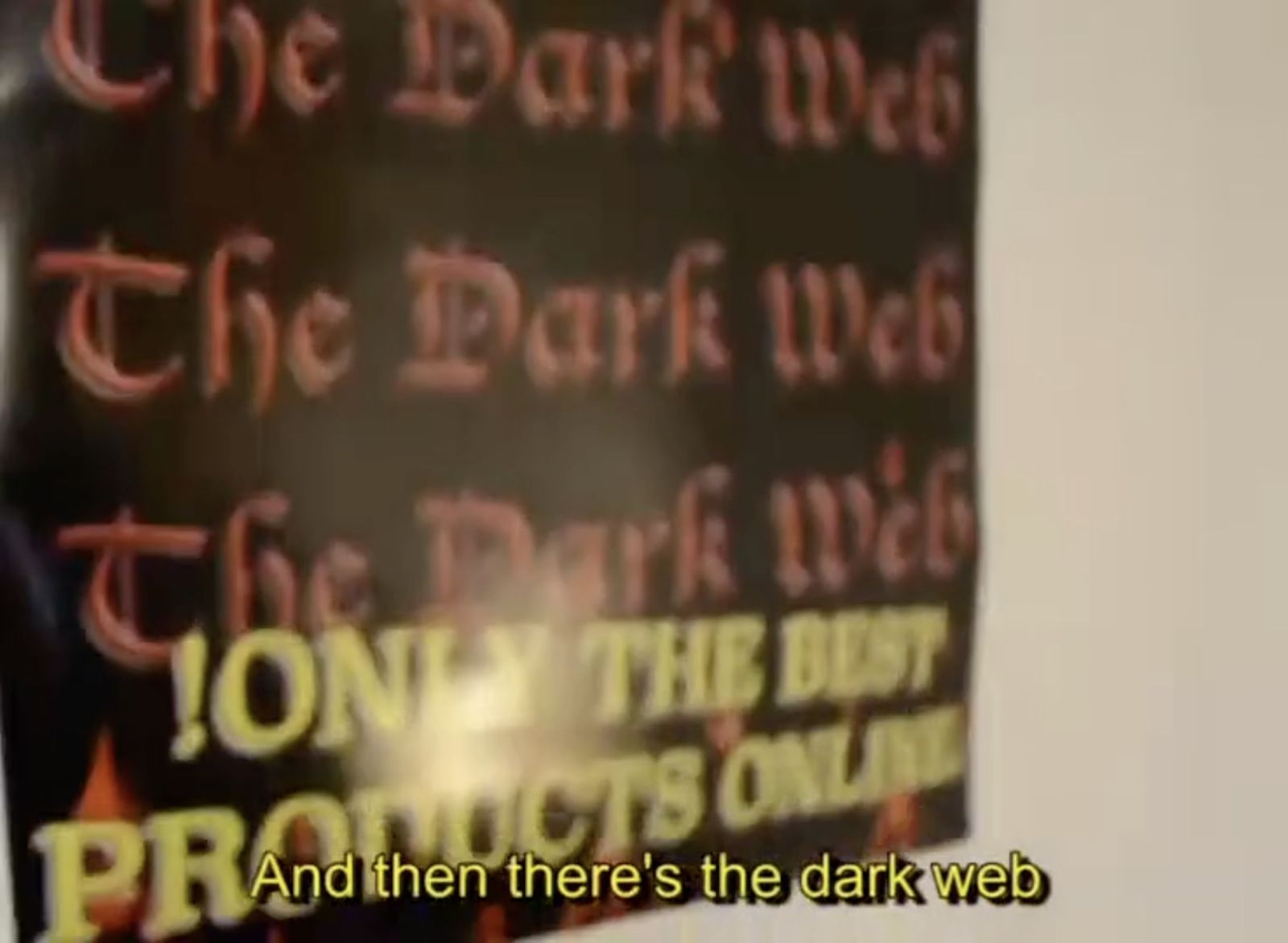 A black poster with red ornamental text that says: The Dark Web, only the best products online! Subtitles say: And then there's the dark web